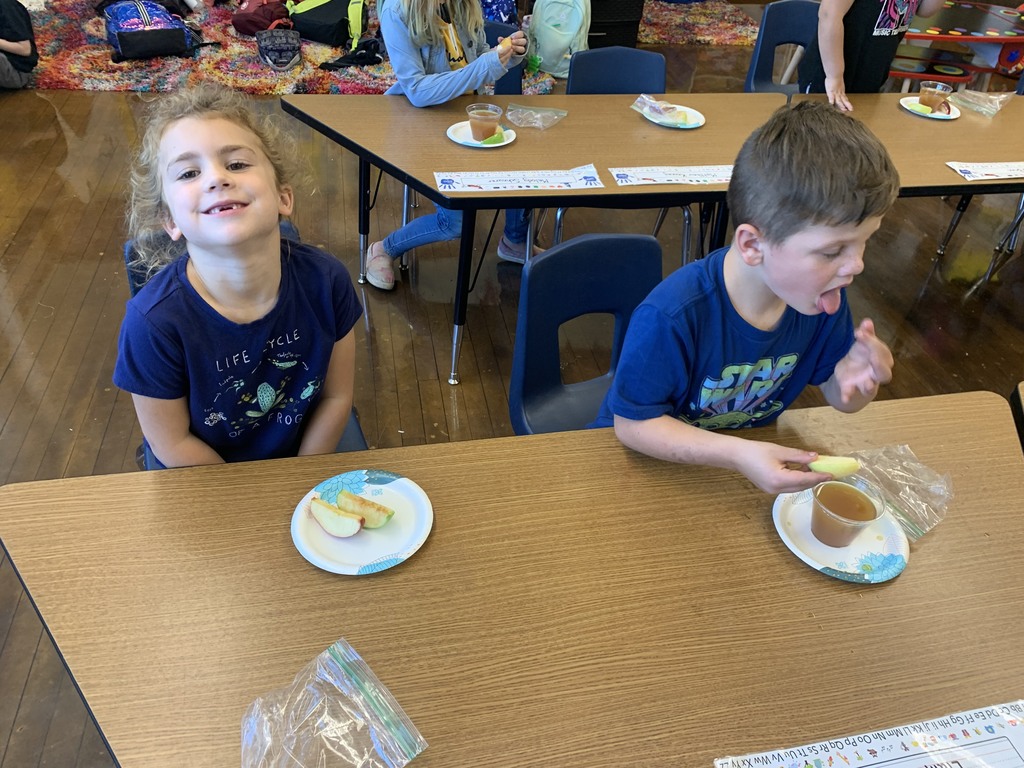 girl and boy eating apple slices