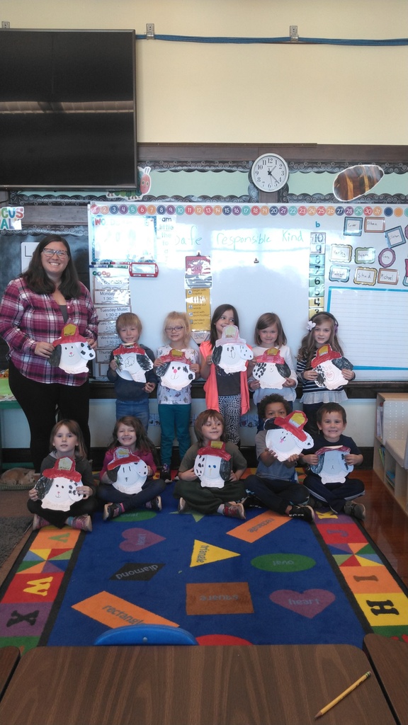 kindergarten students holding fire dog crafts