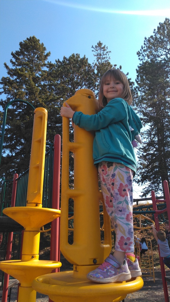 girl on playground equipment
