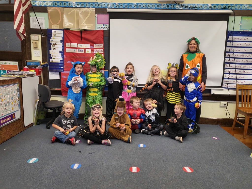 Kindergarten students and teacher in Halloween costumes