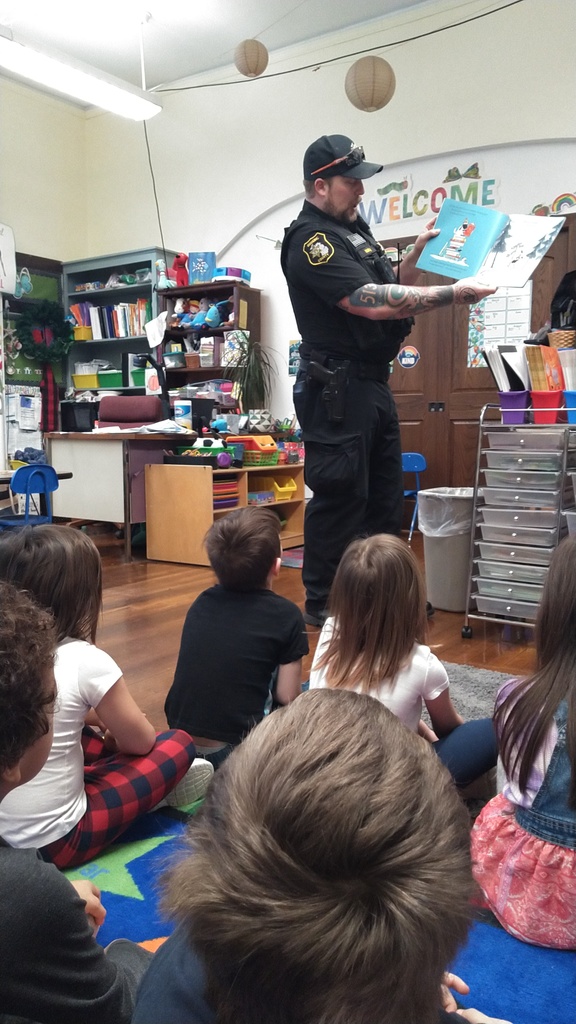 Police officer reading to students