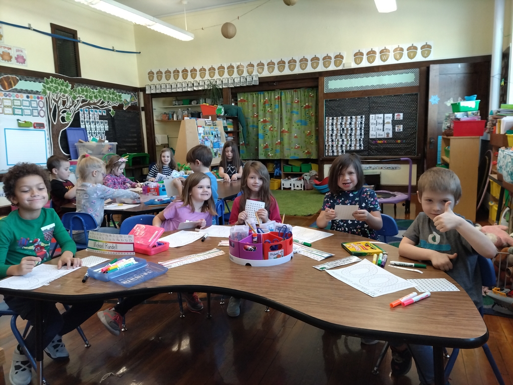 kindergarten students sitting at classroom table