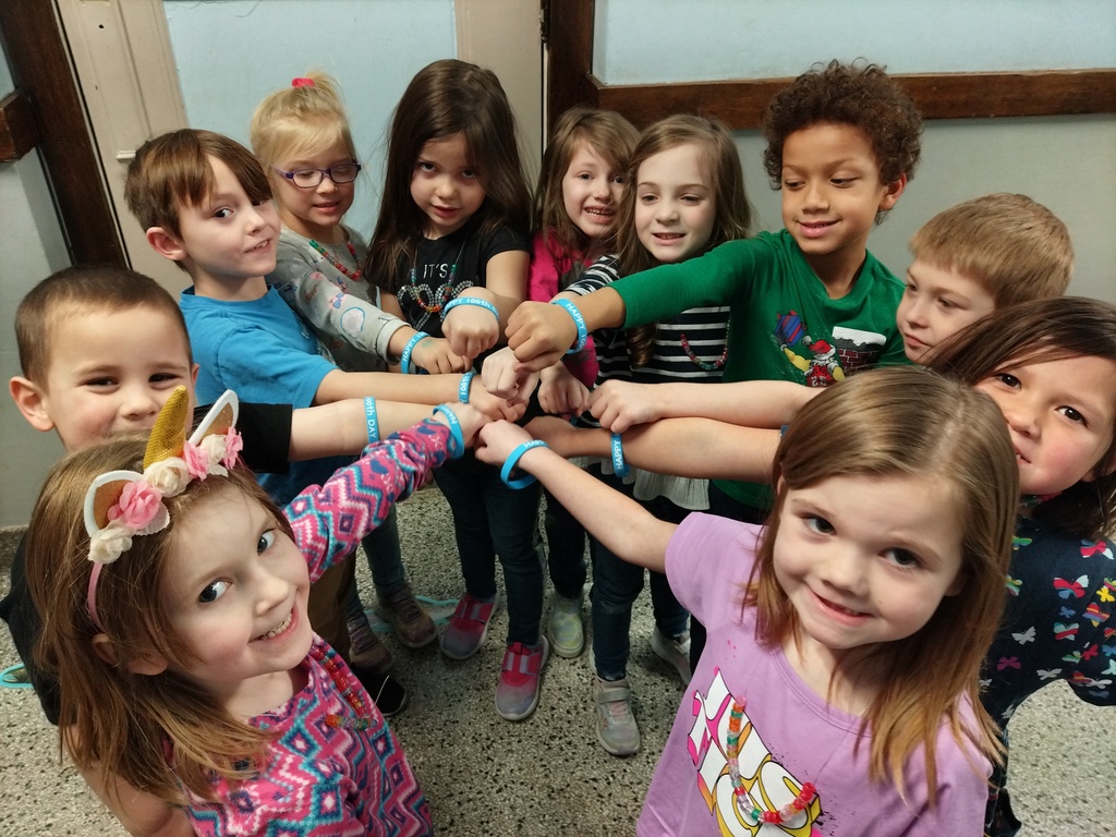 kindergarten students touching fists
