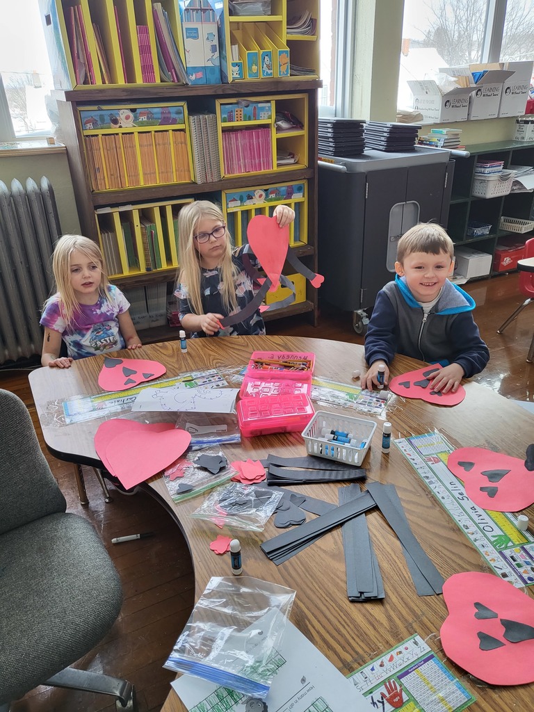 kindergarten students making Valentine crafts