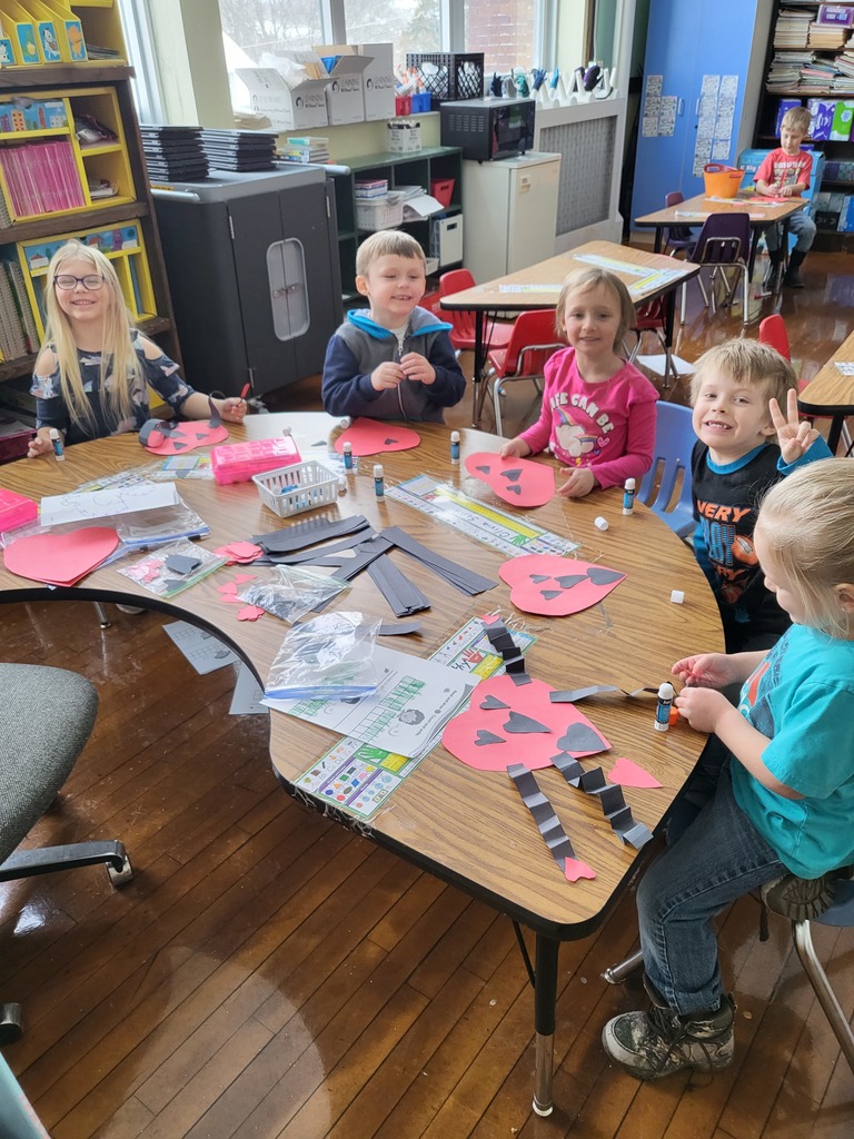 kindergarten students making Valentine crafts