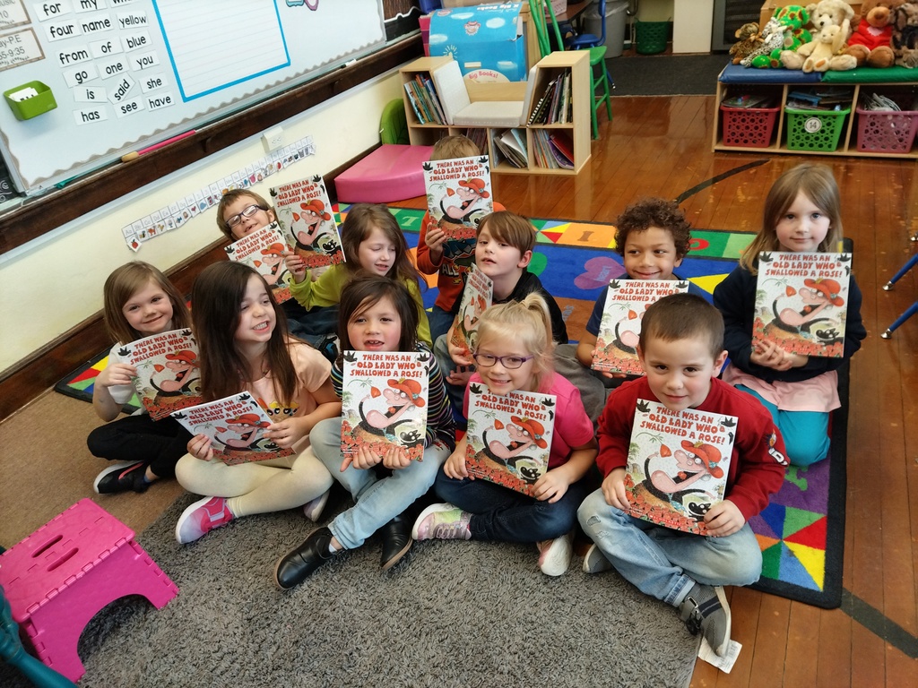 Kindergarten students holding books