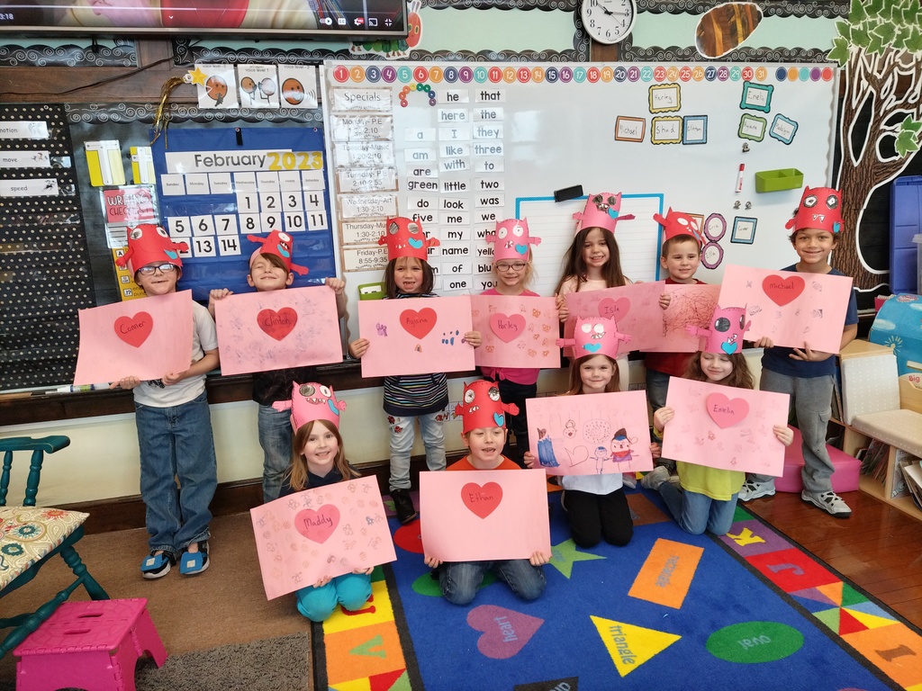 Kindergarten students holding Valentine craft