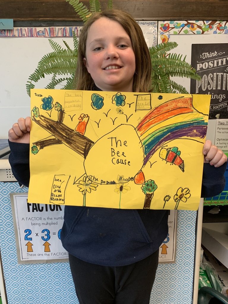 Student holding Save the Bees poster