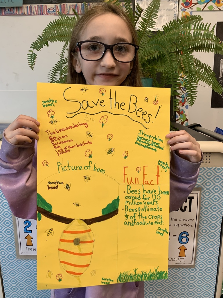 Student holding Save the Bees poster