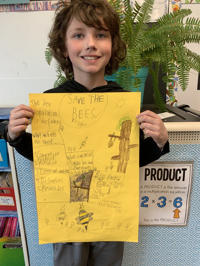 student holds "Bee Cause" poster