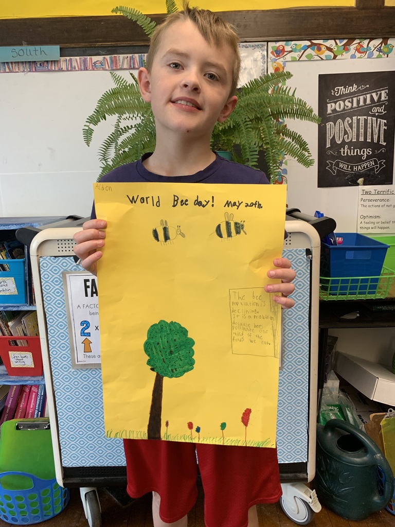 student holds "Bee Cause" poster