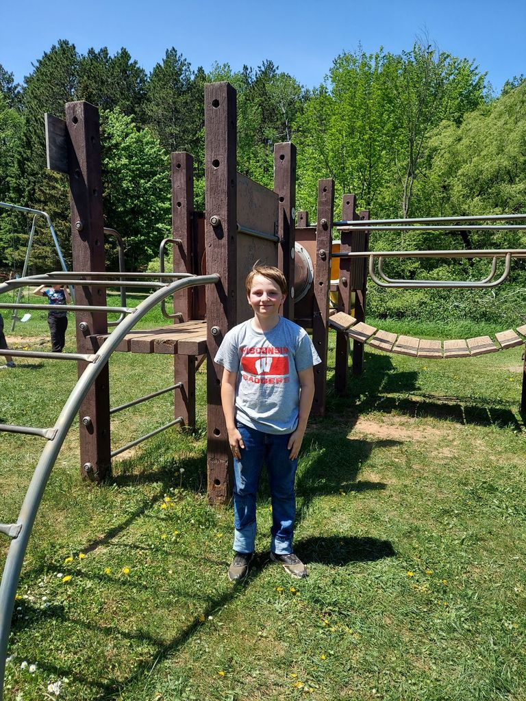 boy standing by playground equipment
